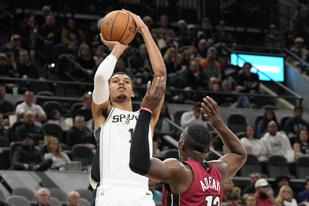 Nov 12, 2023; San Antonio, Texas, USA; San Antonio Spurs center Victor Wembanyama (1) shoots over Miami Heat center Bam Adebayo (13) during the first half at Frost Bank Center.